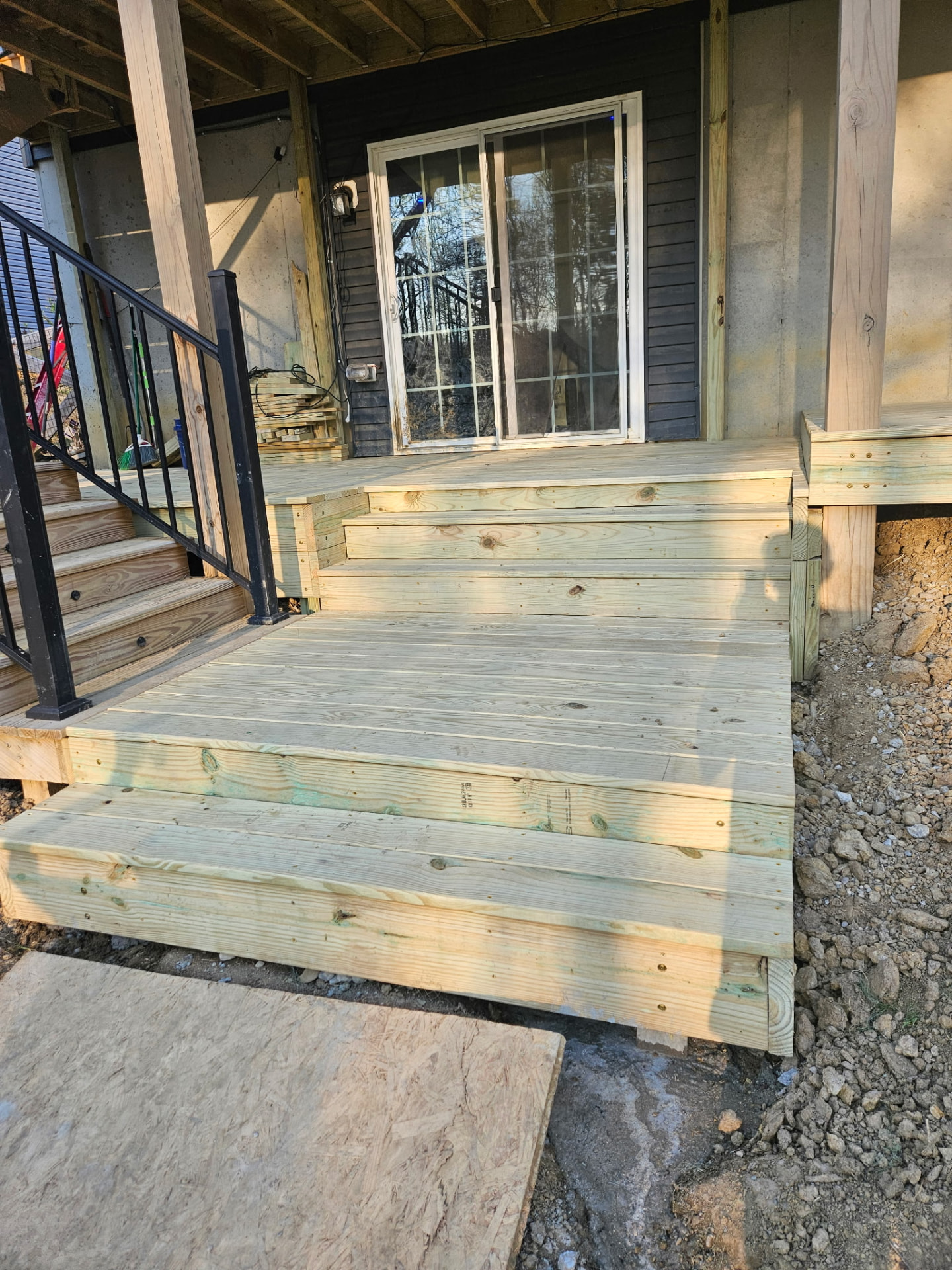 New deck landing and wide steps built at a sliding patio door